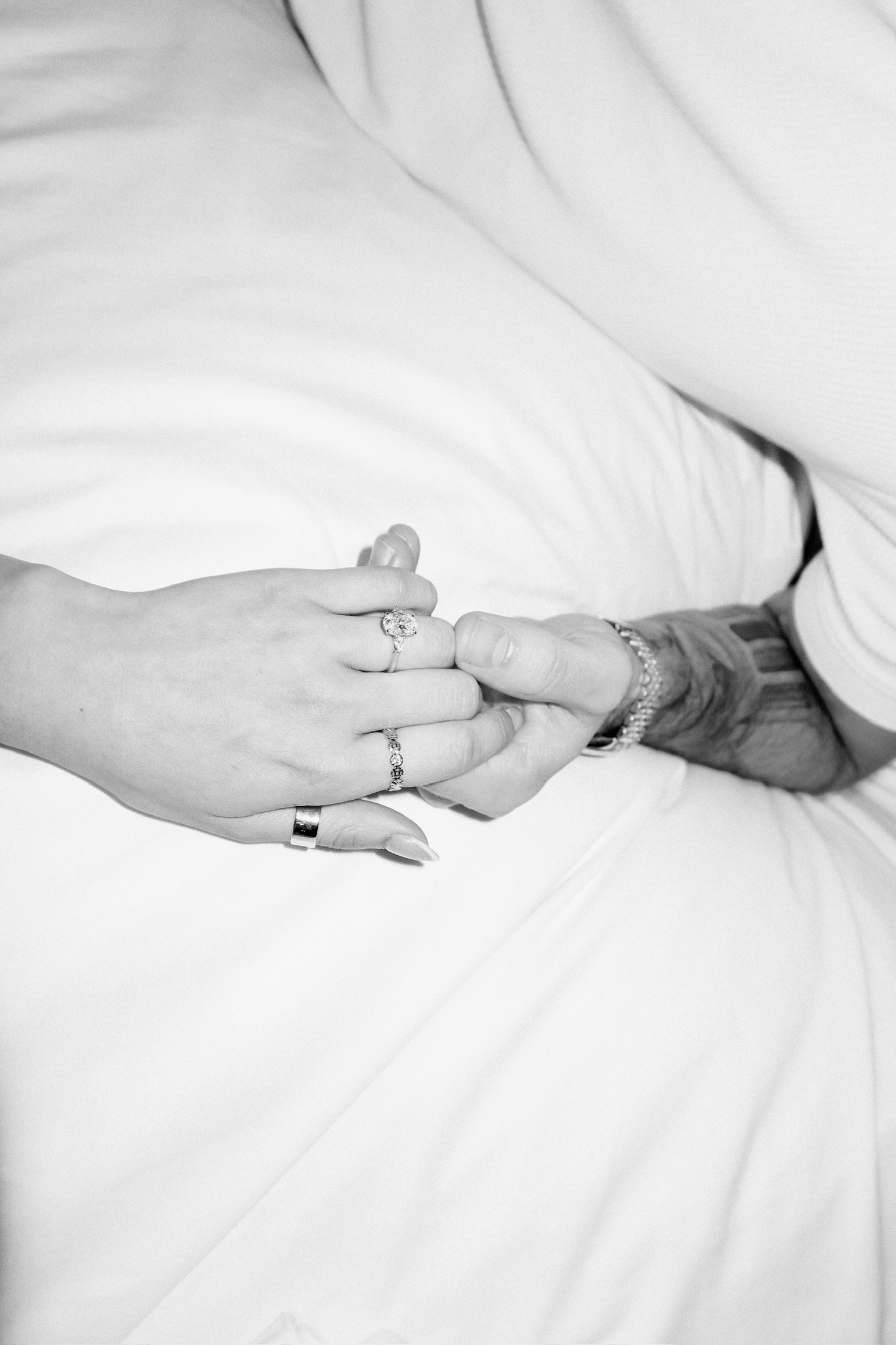 An engagement ring and hands held together